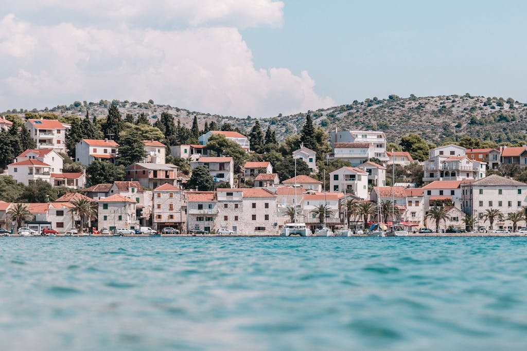 Charming coastal town in Croatia with distinctive red-roofed houses and Mediterranean ambiance.