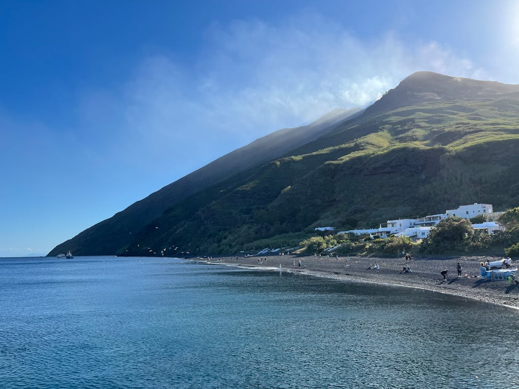 Breathtaking seaside view of Stromboli Island, showcasing a dramatic volcanic landscape and serene waters.